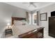 Serene bedroom with a large bed, ceiling fan, natural light, and neutral-colored walls at 8536 Wolverton Fields Dr, Wake Forest, NC 27587