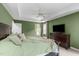 Primary bedroom with tray ceilings, fan, and a view to the primary bath at 8536 Wolverton Fields Dr, Wake Forest, NC 27587