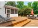 Expansive wooden deck features outdoor seating, a grill, and stairs leading to the backyard at 8536 Wolverton Fields Dr, Wake Forest, NC 27587