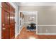 Inviting dining room with hardwood floors, elegant chandelier, and view to the front door at 8536 Wolverton Fields Dr, Wake Forest, NC 27587