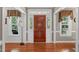 Elegant foyer with hardwood floors, decorative windows, and a solid wood front door at 8536 Wolverton Fields Dr, Wake Forest, NC 27587