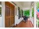 Charming front porch featuring rocking chairs, wood flooring, and scenic outdoor views at 8536 Wolverton Fields Dr, Wake Forest, NC 27587
