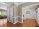 Hallway featuring hardwood floors and views into the living and dining rooms at 8536 Wolverton Fields Dr, Wake Forest, NC 27587