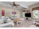 Spacious living room featuring a TV, ceiling fan, lots of natural light, and ample seating at 8536 Wolverton Fields Dr, Wake Forest, NC 27587