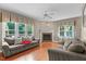 Bright living room with hardwood floors, fireplace, neutral paint, and large windows for natural light at 8536 Wolverton Fields Dr, Wake Forest, NC 27587