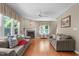 Inviting living room featuring hardwood floors, fireplace, comfortable seating, and ample natural light at 8536 Wolverton Fields Dr, Wake Forest, NC 27587