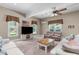 Cozy living room with a ceiling fan, multiple windows, comfortable sofas, and a wooden coffee table at 8536 Wolverton Fields Dr, Wake Forest, NC 27587