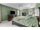 Spacious main bedroom features a tray ceiling, fan, large bed, and two windows for natural light at 8536 Wolverton Fields Dr, Wake Forest, NC 27587