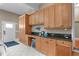 Mudroom with wooden cabinetry, a dark countertop, a drink fridge, and tile flooring at 8536 Wolverton Fields Dr, Wake Forest, NC 27587