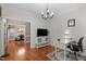 Cozy office space with hardwood floors, chandelier, and modern decor, perfect for a home workspace at 8536 Wolverton Fields Dr, Wake Forest, NC 27587