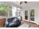 Comfortable sunroom with screened windows, ceiling fan, wood paneled walls, and deck access at 8536 Wolverton Fields Dr, Wake Forest, NC 27587