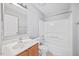 Bright bathroom featuring a single sink vanity, a large mirror, and a shower-tub combo at 8630 Neuse Landing # 105, Raleigh, NC 27616