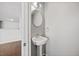Stylish half-bathroom featuring a modern pedestal sink and elegant fixtures for added convenience at 8630 Neuse Landing # 105, Raleigh, NC 27616