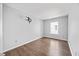 This bedroom has hardwood floors, neutral gray walls, and a bright window at 8630 Neuse Landing # 105, Raleigh, NC 27616