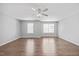 Spacious bedroom featuring a ceiling fan, hardwood flooring, and natural light from two windows at 8630 Neuse Landing # 105, Raleigh, NC 27616