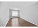 The bedroom has hardwood floors, neutral gray walls, and a bright window at 8630 Neuse Landing # 105, Raleigh, NC 27616