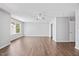 Large bedroom features hardwood floors, ceiling fan, and window view at 8630 Neuse Landing # 105, Raleigh, NC 27616