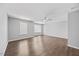 Large bedroom with a ceiling fan, hardwood floors, and a bright window at 8630 Neuse Landing # 105, Raleigh, NC 27616