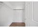 Bright walk-in closet with wood floor and coated-wire shelving for optimal storage and organization at 8630 Neuse Landing # 105, Raleigh, NC 27616