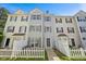 Charming townhomes with varied colors and a quaint white picket fence in a friendly neighborhood at 8630 Neuse Landing # 105, Raleigh, NC 27616