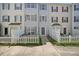 Charming townhouse featuring a welcoming entrance, well-maintained lawn, and classic white picket fence at 8630 Neuse Landing # 105, Raleigh, NC 27616