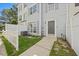 Attractive townhouse featuring a tidy front yard and a freshly painted exterior with a modern front door at 8630 Neuse Landing # 105, Raleigh, NC 27616