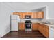 Functional kitchen featuring wooden cabinets, modern appliances, and a practical layout for cooking and dining at 8630 Neuse Landing # 105, Raleigh, NC 27616