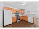 Efficient kitchen showcasing wooden cabinets, a suite of appliances, and bright lighting for comfortable cooking at 8630 Neuse Landing # 105, Raleigh, NC 27616