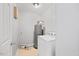 The laundry room has a washing machine, water heater, and gray walls at 8630 Neuse Landing # 105, Raleigh, NC 27616