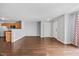 Inviting living room with hardwood floors and neutral walls, transitioning into a modern kitchen area at 8630 Neuse Landing # 105, Raleigh, NC 27616