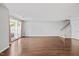Bright and airy living room boasting beautiful hardwood floors and access to the outdoors through a glass door at 8630 Neuse Landing # 105, Raleigh, NC 27616