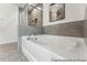 Elegant bathroom showcasing a luxurious soaking tub with tile accents and contemporary fixtures at 88 Mable Court # 17, Lillington, NC 27546