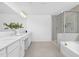 A luxurious bathroom has double vanity, quartz countertops and a glass enclosed shower at 88 Mable Court # 17, Lillington, NC 27546