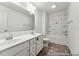 This bathroom includes double sinks, gray cabinets, a large mirror, and modern lighting at 88 Mable Court # 17, Lillington, NC 27546