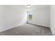 Simple bedroom featuring carpet flooring, neutral walls, and a window for natural light at 88 Mable Court # 17, Lillington, NC 27546