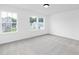 Bright, empty bedroom with multiple windows offering ample natural light and views of the neighborhood at 88 Mable Court # 17, Lillington, NC 27546