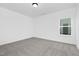 A light-filled bedroom features neutral walls, carpet, and a bright window at 88 Mable Court # 17, Lillington, NC 27546