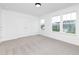 Comfortable bedroom featuring natural light, neutral carpeting, and ample closet space at 88 Mable Court # 17, Lillington, NC 27546