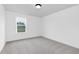 A light-filled bedroom features neutral walls, carpet, and a bright window at 88 Mable Court # 17, Lillington, NC 27546