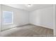 A clean and neutral bedroom featuring a window and carpeted floors at 88 Mable Court # 17, Lillington, NC 27546