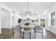 Sun-filled dining area opens to the kitchen and living area, with a modern light fixture at 88 Mable Court # 17, Lillington, NC 27546
