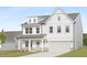 Beautiful two-story home boasts a crisp white facade, an attached two-car garage, and manicured lawn at 88 Mable Court # 17, Lillington, NC 27546