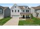Charming two-story home with white siding, a two-car garage, and a well-manicured lawn at 88 Mable Court # 17, Lillington, NC 27546
