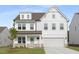 Charming two-story home boasts a crisp white facade, an attached two-car garage, and beautifully manicured lawn at 88 Mable Court # 17, Lillington, NC 27546