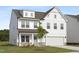 Two-story home features a crisp white facade, an attached two-car garage, well-maintained lawn, and welcoming entry at 88 Mable Court # 17, Lillington, NC 27546