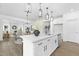 A spacious kitchen with stainless appliances, quartz countertops, subway tile backsplash, and is open to the living room at 88 Mable Court # 17, Lillington, NC 27546
