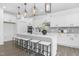 A spacious kitchen features stainless appliances, quartz countertops, subway tile backsplash, and seating for four at 88 Mable Court # 17, Lillington, NC 27546