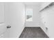 Laundry room boasts wood-look flooring and built in shelving at 88 Mable Court # 17, Lillington, NC 27546
