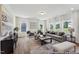 Bright and airy living room with lots of windows, stylish furniture, and hardwood floors at 88 Mable Court # 17, Lillington, NC 27546
