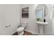Modern powder room with a pedestal sink, round mirror, and neutral decor at 88 Mable Court # 17, Lillington, NC 27546